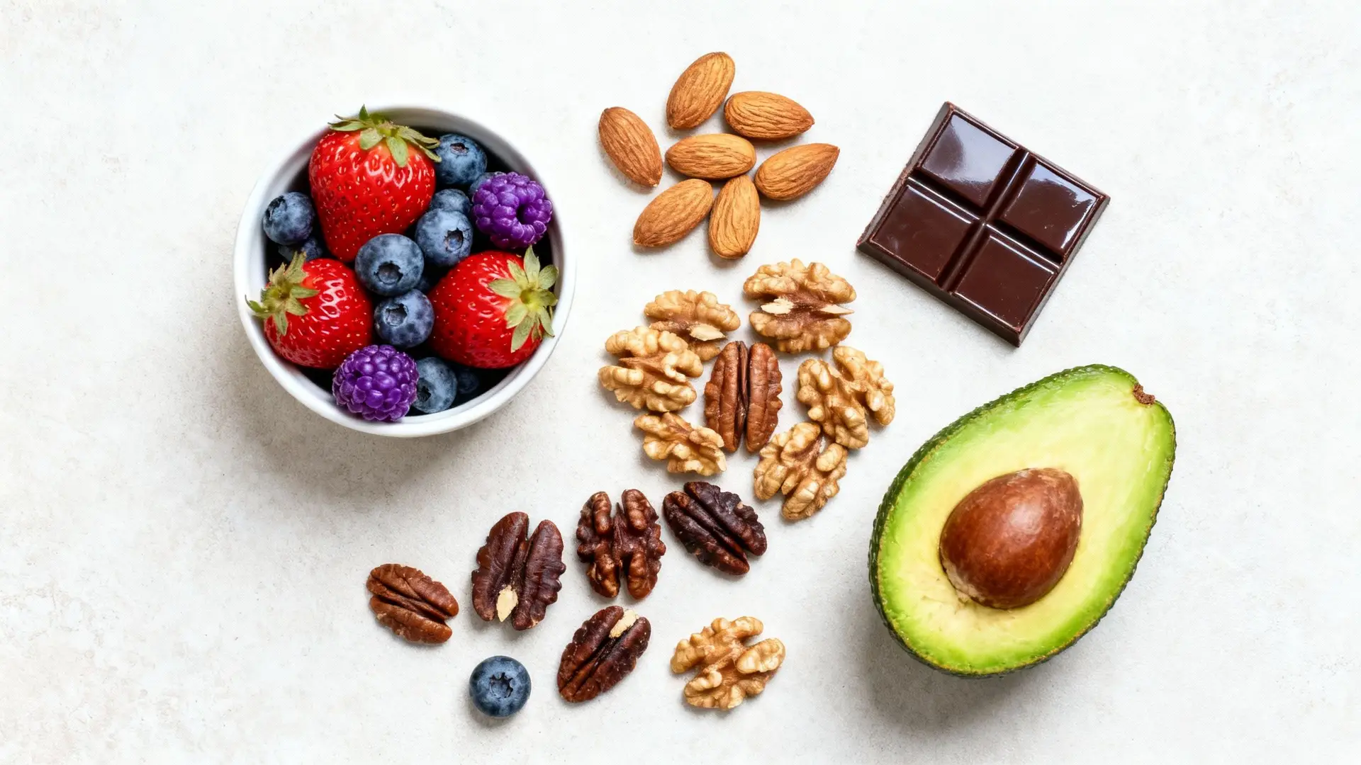 Assortment of heart-healthy snacks like berries, nuts, and dark chocolate.
